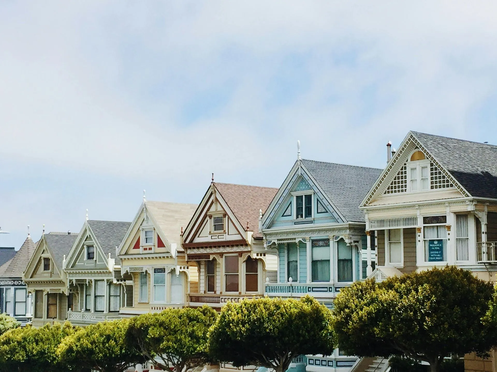 Row of colorful Victorian houses with gabled roofs, San Francisco.